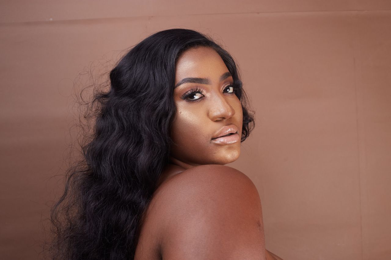 A captivating portrait of a woman with glamorous makeup and wavy hair exuding beauty and confidence.