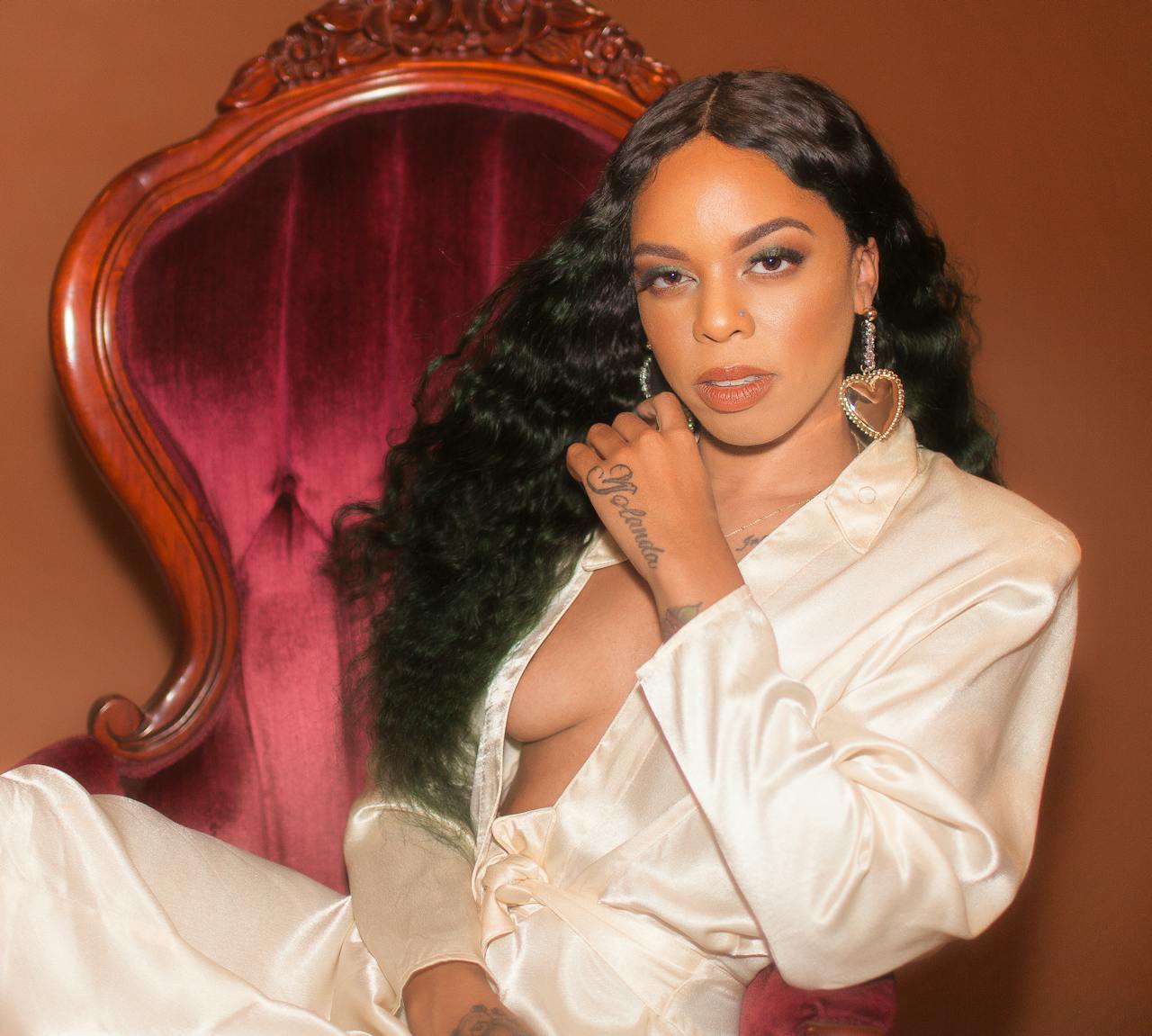 The Art of Drawing Readers In: Your attractive post title goes here Seductive African American female in elegant clothes relaxing on chair and looking at camera